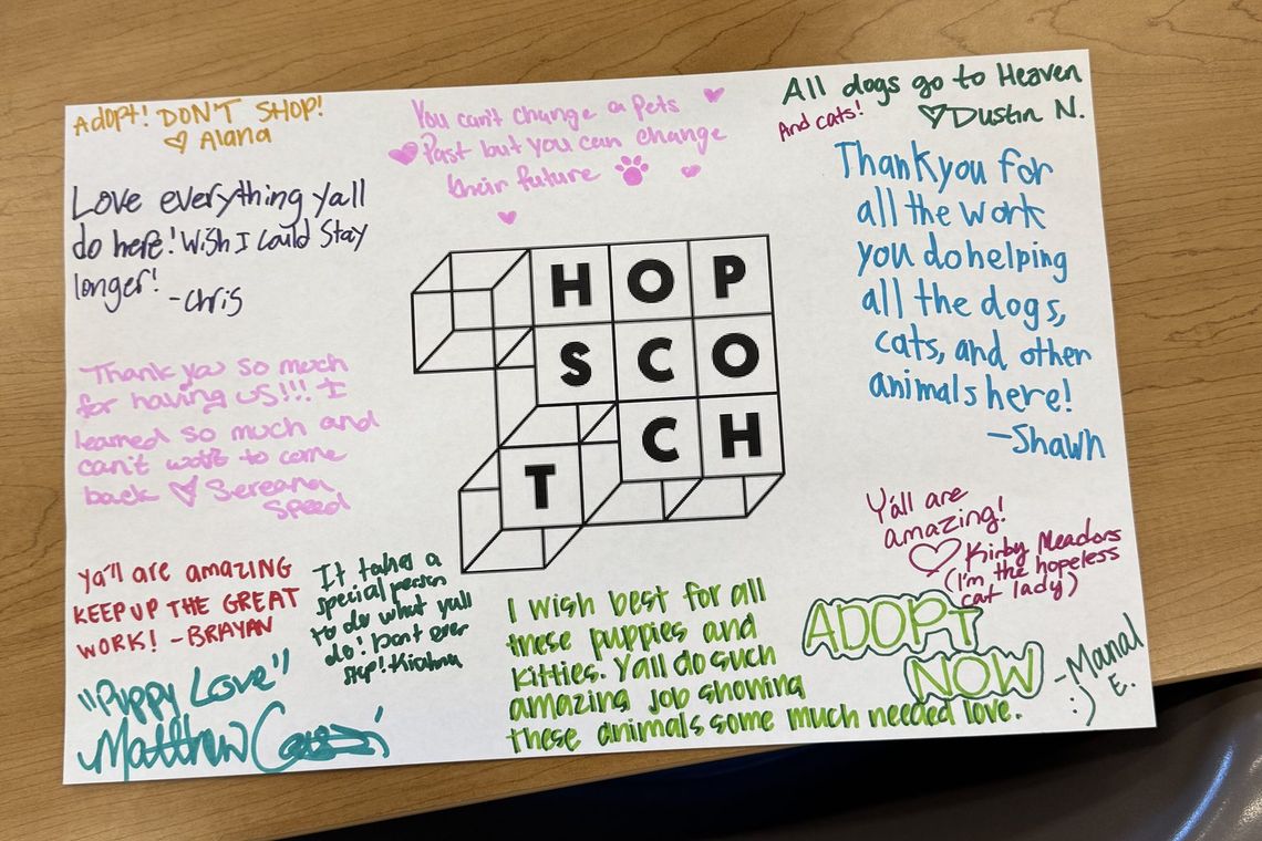 A handwritten thank-you card from the Hopscotch team to the shelter staff, signed by the volunteers