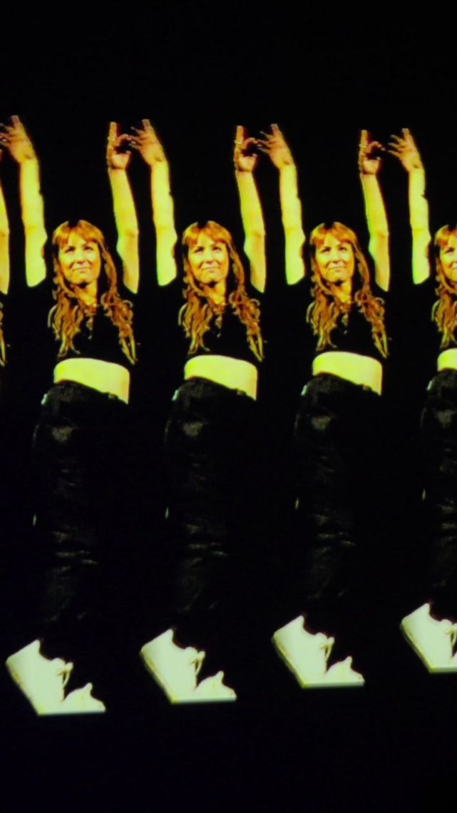A row of gold echoes of one dancer, arms raised, receding across the screen.