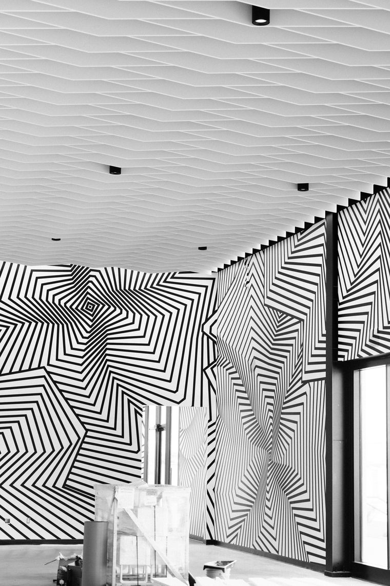 Detail of Darel Carey’s angular black-and-white op art stripes across the Los Angeles lounge walls.