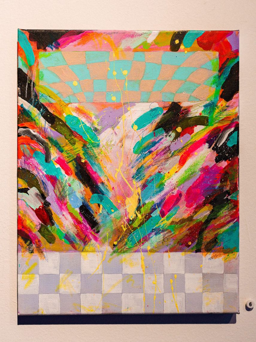 A painting by Ursula Zavala: an explosion of coloured strokes between a checkered sky and a checkered floor.