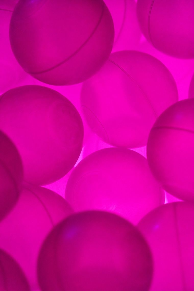 Close up of the translucent balls in Diodic Daydream, all lit a deep pink.