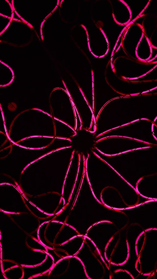 Looking straight up into the centre of Medusa, tubes radiating out in a starburst of looping pink light.